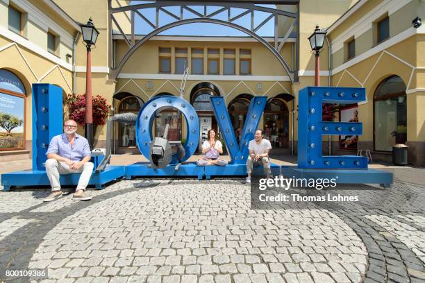 Kay Niehaus , Business Director of the Ingolstadt and Wertheim Village, Jana Pallaske and artist Il-Jin Atem Chio pose next to the sculptures of the...