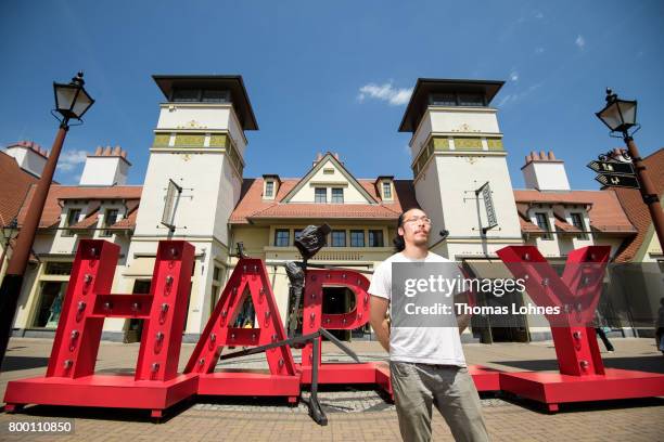 The artist Il-Jin Atem Chio pictured next to on of his skulptures at Wertheim Village on June 20, 2017 in Wertheim, Germany. Il-Jin Atem Chio has...