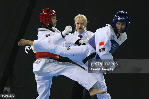 China's Zhou Zhuohui competes against Philippines' Kathleen Eunice Alora during the women's under 49kg at the 'Good Luck Beijing' 2008 International...