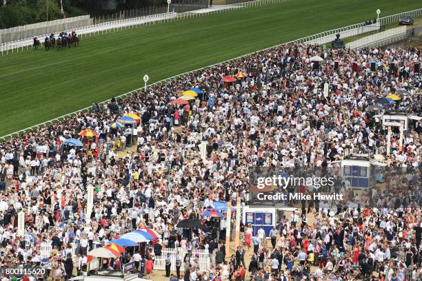 Runners and riders make their way past the vast crowd in the Commonwealth Cup on Day Four of Royal Ascot at Ascot Racecourse on June 23, 2017 in...