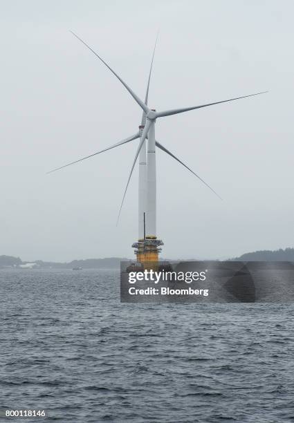 Barges position offshore floating wind turbines during assembly in the Hywind pilot park, operated by Statoil ASA, in Stord, Norway, on Friday, June...