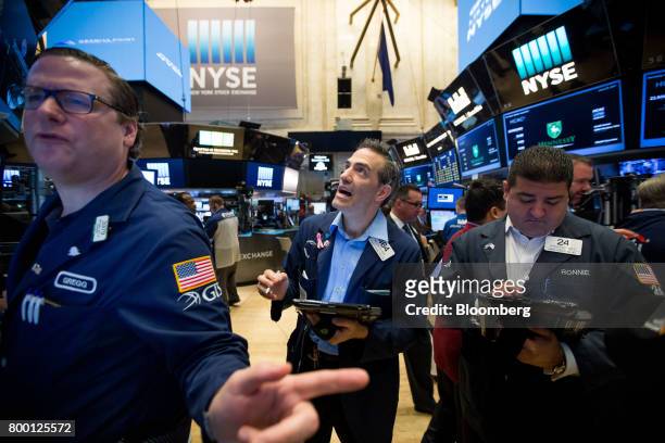Traders work on the floor of the New York Stock Exchange in New York, U.S., on Friday, June 23, 2017. U.S. Stocks edged higher, while Treasuries and...