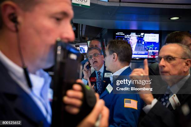 Traders work on the floor of the New York Stock Exchange in New York, U.S., on Friday, June 23, 2017. U.S. Stocks edged higher, while Treasuries and...