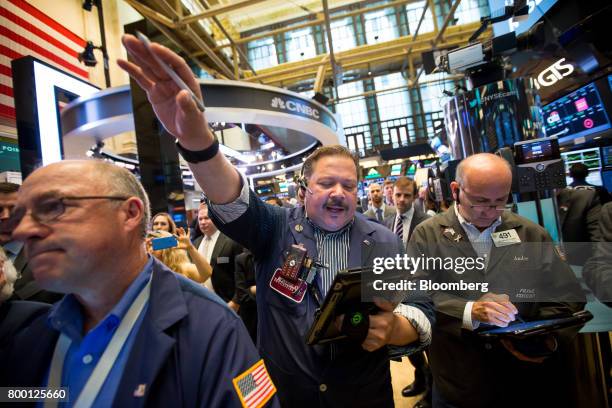 Traders work on the floor of the New York Stock Exchange in New York, U.S., on Friday, June 23, 2017. U.S. Stocks edged higher, while Treasuries and...