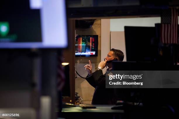 Trader talks on the phone while working on the floor of the New York Stock Exchange in New York, U.S., on Friday, June 23, 2017. U.S. Stocks edged...