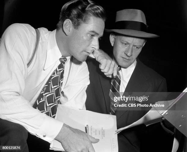 Radio program, Silver Theater, featuring from left: actor Errol Flynn and program host Conrad Nagel. They prepare for the presentation of "For...