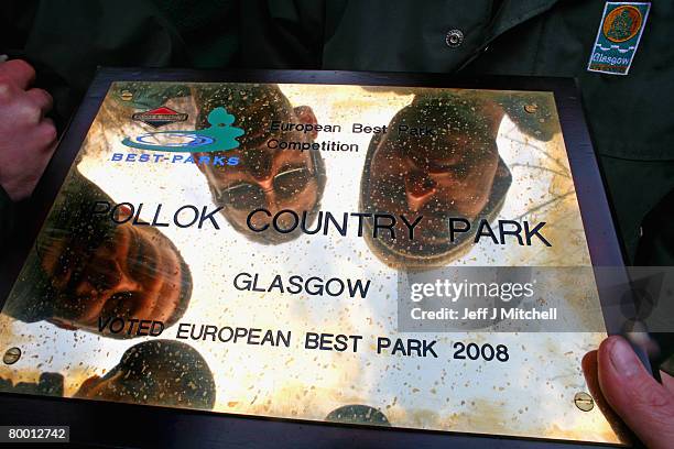 Gardeners view a plaque at Pollok Country Park on February 26, 2008 in Glasgow, Scotland. The park has been named Europe's best park for 2008 by...