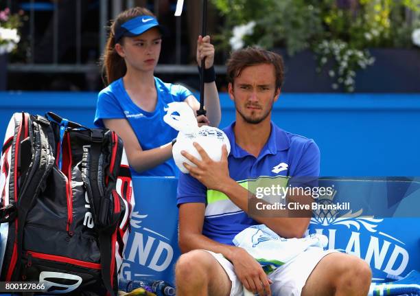 Daniil Medvedev of Russia holds an ice pack over his injury during the mens singles quarter final match against Grigor Dimitrov of Bulgaria on day...