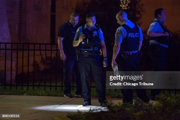 Chicago Police officers work at the scene where a 14-year-old and 15-year old boy were shot in the 2600 block of West Hirsch Street Thursday, June 22...