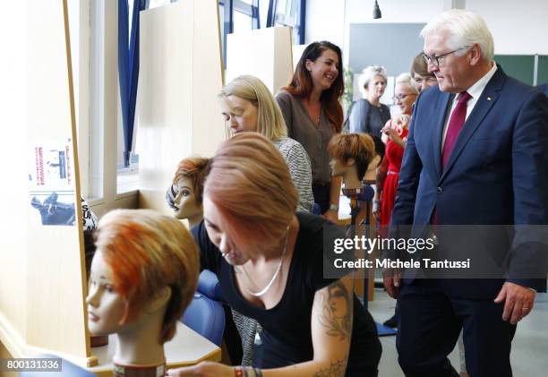 German President Frank-Walter Steinmeier and First Lady Elke Buedenbender Chat with trainees attending the coiffeurs - hair styling course while...