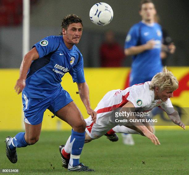 Stuttgart's Andreas Beck vies with Jena's Marcel Schied during their German Cup quarterfinal football match on February 26, 2008 in Stuttgart. AFP...