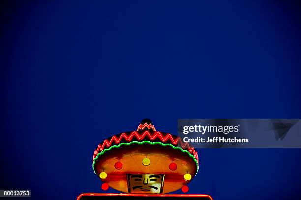 The sombrero glows on a Mexican themed statue holding a bright neon sign advertising South of the Border to drivers passing by on I-95 at South of...