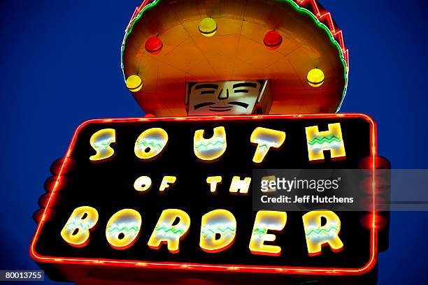 Mexican themed statue holds a glowing neon sign advertising South of the Border to drivers passing by on I-95 at South of the Border on July 21, 2006...