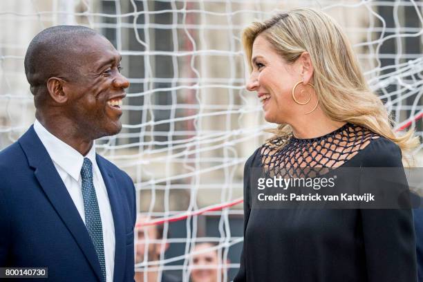 Clarence Seedorf and Queen Maxima of The Netherlands attend a soccer clinic with dutch former players Clarence Seedor, Aaron Winter, Pierre van...