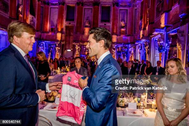 King Willem-Alexander of The Netherlands congratulates Dutch Tom Dumoulin winner of the Giro D'Italia during the third day of a royal state visit to...