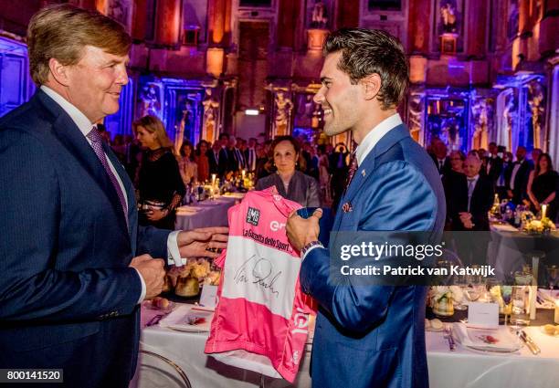 King Willem-Alexander of The Netherlands congratulates Dutch Tom Dumoulin winner of the Giro D'Italia during the third day of a royal state visit to...