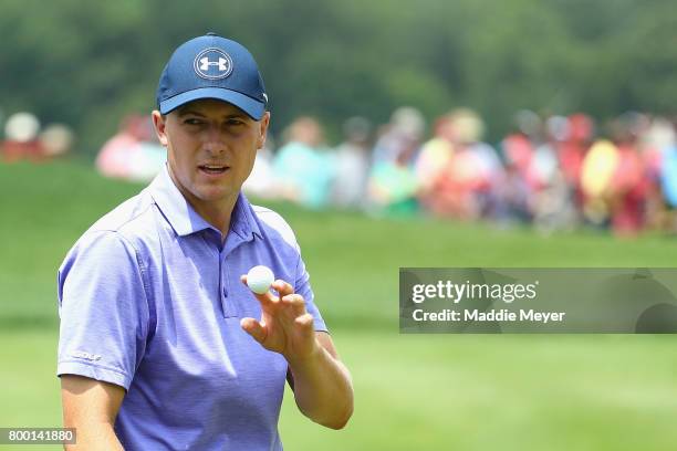 Jordan Spieth of the United States acknowledges the crowd after putting on the ninth green during the second round of the Travelers Championship at...