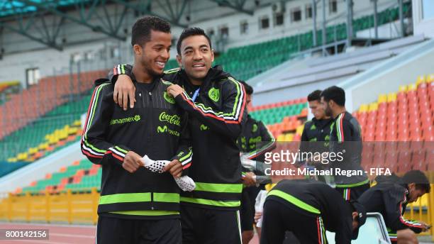 Jonathan dos Santos and Marco Fabian share a joke during the Mexico training session on June 23, 2017 in Kazan, Russia.