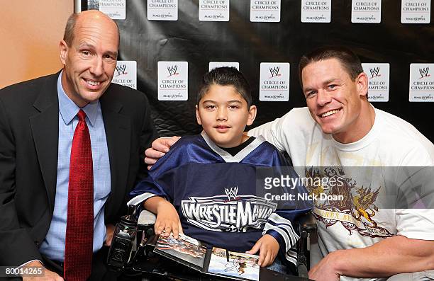 Make-Wish foundation president David Williams, Max and WWE SuperStar pose for pictures after the announcement of the WWW and Make-A-Wish foundation...