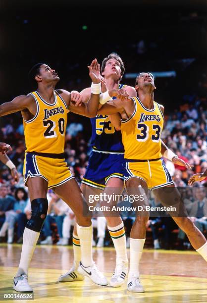 Maurice Lucas and Kareem Abdul-Jabbar of the Los Angeles Lakers box out against the Utah Jazz during a game played circa 1989 at the Great Western...