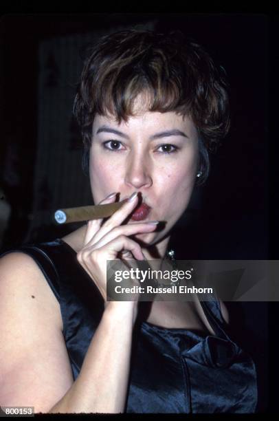 Actress Jennifer Tilly smokes a cigar at a Grammy awards party at Chasens restaurant February 28, 1995 in Los Angeles, CA. Tilly was last seen in the...