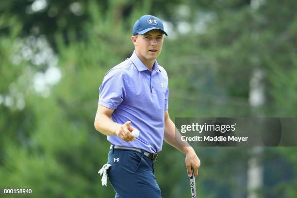 Jordan Spieth of the United States acknowledges the crowd after putting on the eighth green during the second round of the Travelers Championship at...