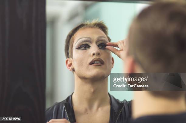 man gets dressed in drag attire in bathroom - cross dressing stock pictures, royalty-free photos & images