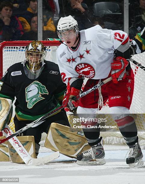 James Livingston of the Sault Ste. Marie Greyhounds waits to deflect a shot next to Jhase Sniderman of the London Knights in a game on February 24,...