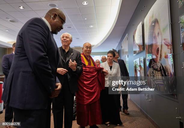 Forest Whitaker speaks with His Holiness the XIVth Dalai Lama, Starkey founder Bill Austin and Tani Austin at the Starkey Hearing Foundation Center...