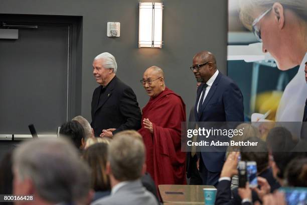 His Holiness the XIVth Dalai Lama, Starkey founder Bill Austin and actor Forest Whitaker enter the room at the Starkey Hearing Foundation Center For...