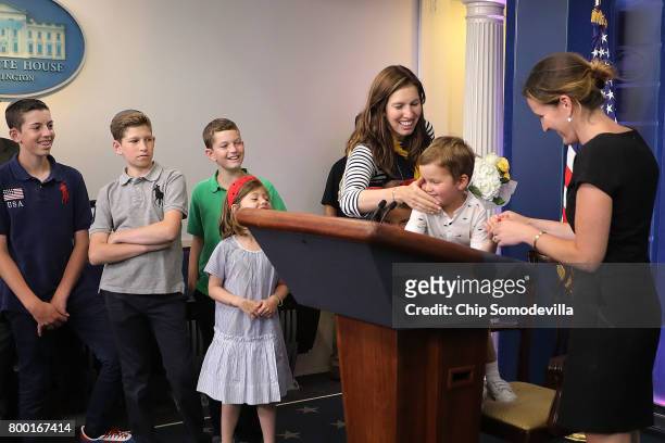 Joseph Frederick Kushner and friends play with the lecturn in the James Brady Press Briefing Room following Press Secretary Sean Spicer's off-camera...