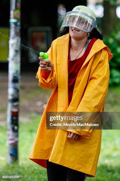 An activist is pictured during a protest against the upcoming G20 summit as they bombard each other with water balloons and squirt guns during a...