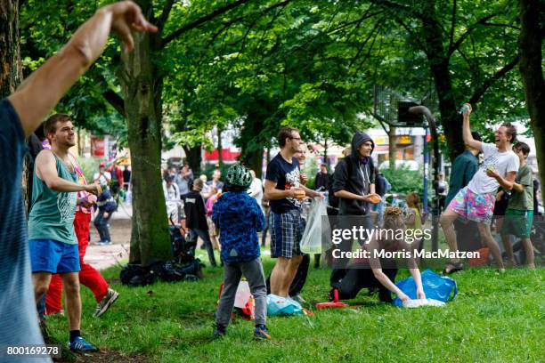 Activists protesting against the upcoming G20 summit bombard each other with water balloons and squirt guns during a creative protest under the motto...