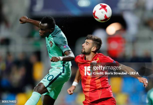 Bruma of Portugal jumps for a header with Egzon Bejtulai of FYR Macedonia during the UEFA European Under-21 Championship Group B match between...