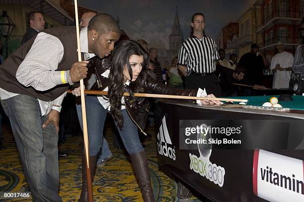 Player Reggie Bush of the New Orleans Saints helps Kim Kardashian with her pool shots at the 2008 NBA All-Star Shaquille O'Neal and Reggie Bush...