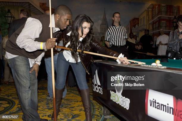 Player Reggie Bush of the New Orleans Saints helps Kim Kardashian with her pool shots at the 2008 NBA All-Star Shaquille O'Neal and Reggie Bush...