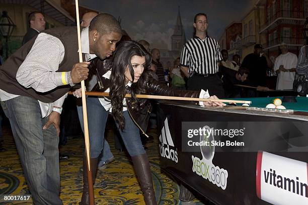 Player Reggie Bush of the New Orleans Saints helps Kim Kardashian with her pool shots at the 2008 NBA All-Star Shaquille O'Neal and Reggie Bush...