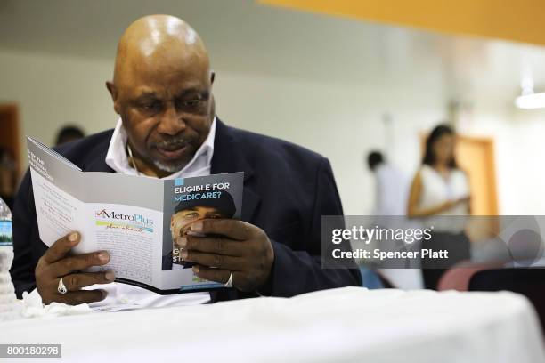 James Cammick reads literature on Medicaid at a Senior Citizens Prom sponsored by the MetroPlus, a prepaid health services plan, on June 23, 2017 in...