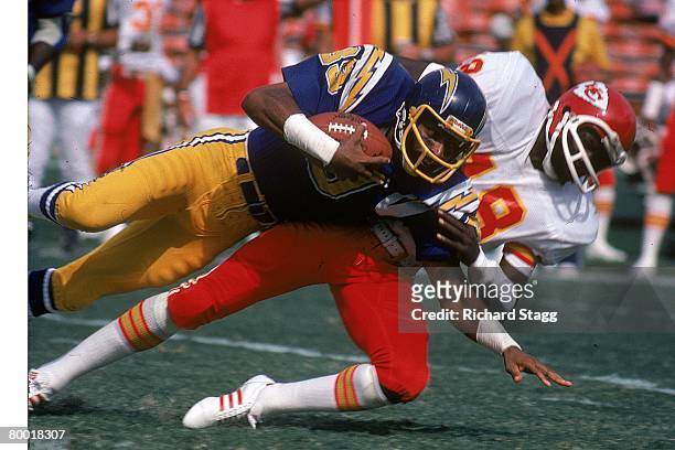 Cornerback Emmitt Thomas of the Kansas City Chiefs tackles wide receiver Dwight McDonald of the San Diego Chargers at San Diego Stadium on October...