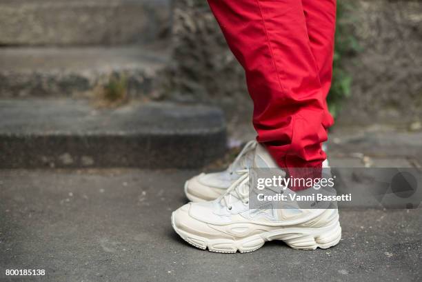 Guest poss wearing Raf Simons shoes after the Namacheko show at the Cloitre des Billetes during Paris Fashion Week Menswear SS18 on June 23, 2017 in...