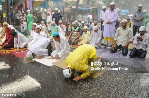 People offer Last Friday Namaz of Ramadan in heavy rain in front of Tipu Sultan Mosque at Esplanade on June 23, 2017 in Kolkata, India.