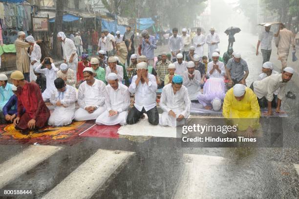 People offer Last Friday Namaz of Ramadan in heavy rain in front of Tipu Sultan Mosque at Esplanade on June 23, 2017 in Kolkata, India.