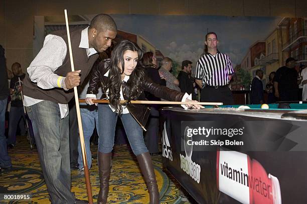 Player Reggie Bush of the New Orleans Saints helps Kim Kardashian with her pool shots at the 2008 NBA All-Star Shaquille O'Neal and Reggie Bush...