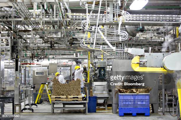 Workers monitors canning lines as fresh peas are processed at the Del Monte Foods Inc. Facility in Mendota, Illinois, U.S., on Friday, June 23, 2017....