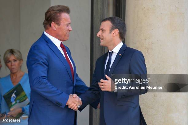 French President Emmanuel Macron shakes hand with Arnold Schwarzenegger after a meeting at the Elysee Palace on June 23, 2017 in Paris, France. On...