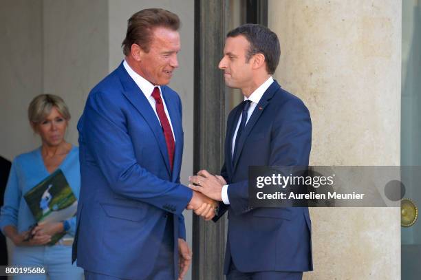 French President Emmanuel Macron shakes hand with Arnold Schwarzenegger after a meeting at the Elysee Palace on June 23, 2017 in Paris, France. On...