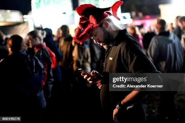 Festival goer tries to write a message with his smartphone during the Hurricane Festival 2017 on June 23, 2017 in Scheessel, Germany. The gates of...