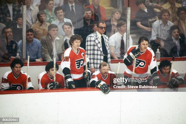 Coach Fred Shero of the Philadelphia Flyers along with players Jimmy Watson, Dave Hoyda, Bobby Clarke, Bob Kelly, Bill Barber and Reggie Leach watch...