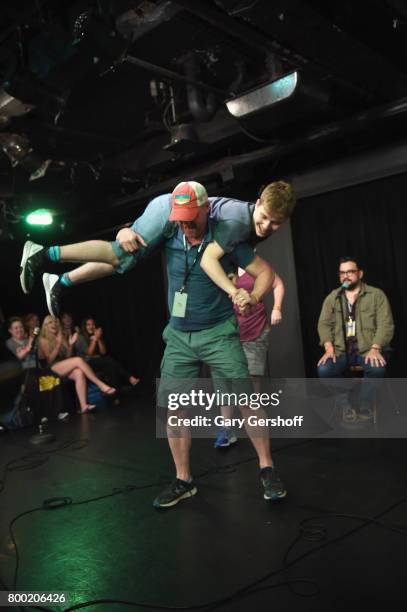 Matt Walsh performs on stage with an audience member during the 19th Annual Del Close Improv Comedy Marathon Press Conference at Upright Citizens...