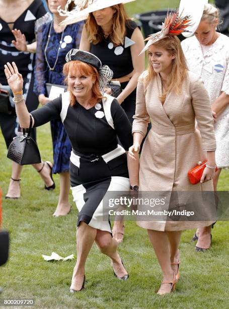 Sarah Ferguson, Duchess of York and Princess Beatrice curtsey to Queen Elizabeth II as they attend day 4 of Royal Ascot at Ascot Racecourse on June...